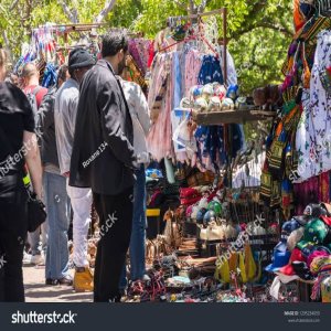 Busy market stalls lining a city pavement